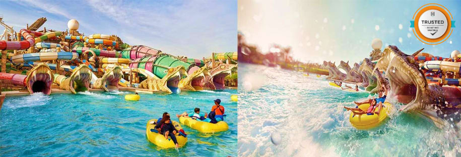 Families enjoying yellow inflatable rides at Yas Water World water park with colorful tube slides in background under blue sk